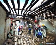 Workers repair sutra printing house Meru Monastery in China's Tibet