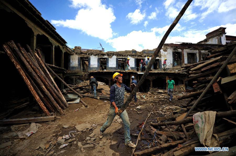 Workers put disassembled beams aside as they repair sutra printing house Meru Monastery in Lhasa, capital of southwest China's Tibet Autonomous Region, Aug. 28, 2015. Local government has dispatched about 30 million yuan (4.698 million US dollars) to overhaul Meru Monastery, which has a history of more than 400 years and suffered from deformation in its beam, pillars and walls. The repair, which started on Aug. 1, is expected to last for one year. (Xinhua/Jigme Dorje)