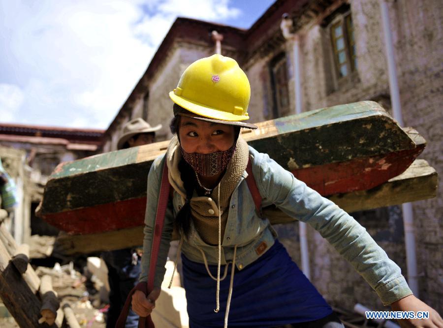 A worker carries a beam while repairing sutra printing house Meru Monastery in Lhasa, capital of southwest China's Tibet Autonomous Region, Aug. 28, 2015. Local government has dispatched about 30 million yuan (4.698 million US dollars) to overhaul Meru Monastery, which has a history of more than 400 years and suffered from deformation in its beam, pillars and walls. The repair, which started on Aug. 1, is expected to last for one year.(Xinhua/Jigme Dorje)