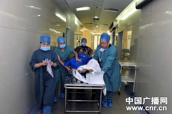 Two-year-old Tsering Kangco is pushed-off the operating room after surgery.