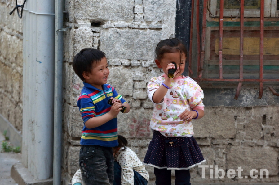 Photo shows a child walking on the Barkhor Street. [Photo/ China Tibet Online]