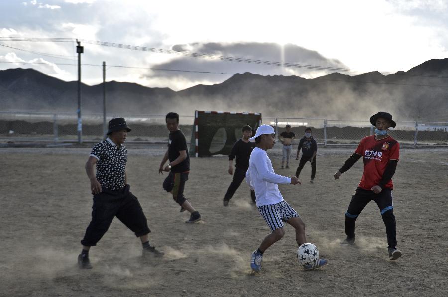 Youngsters play football at relocation sites in Shigatse, Tibet