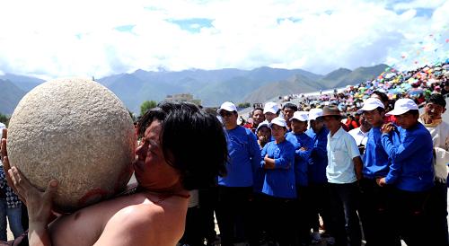 A Tibetan participate in the stone carrying match during the Shoton Festival, Aug 11.