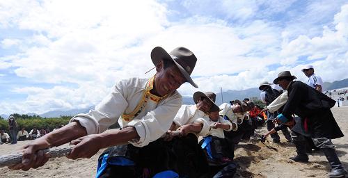Local Tibetans take part in the tug of war during the Shoton Festival, Aug 11.