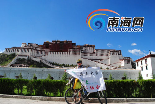Zhou Qiang, a sophomore of China's Hainan University stands in front of the Potala Palace.